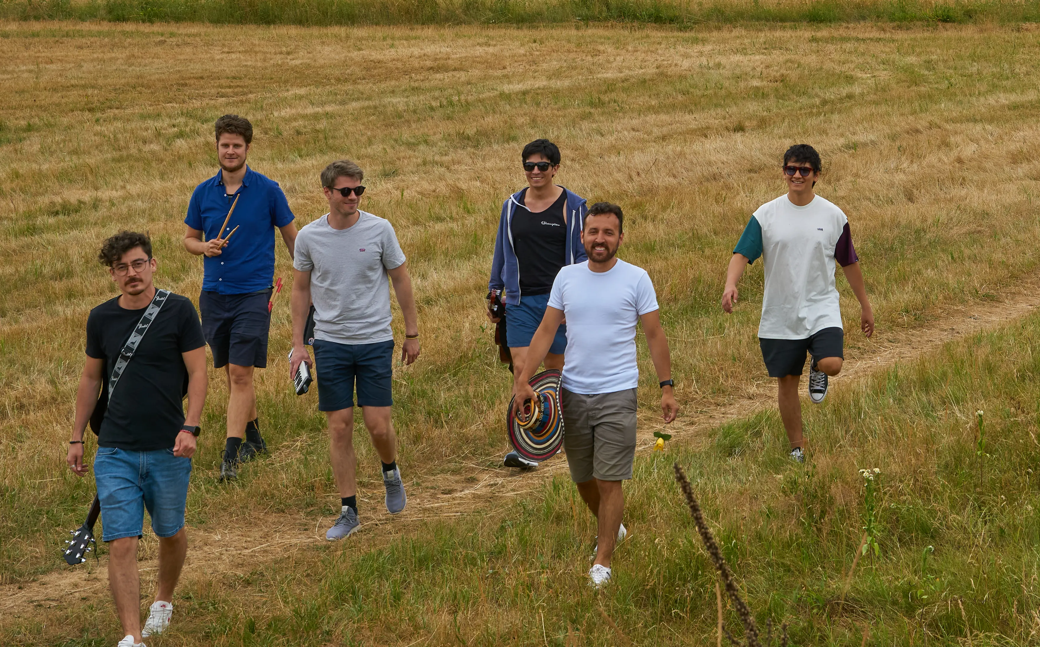 The band members walking around on a meadow
