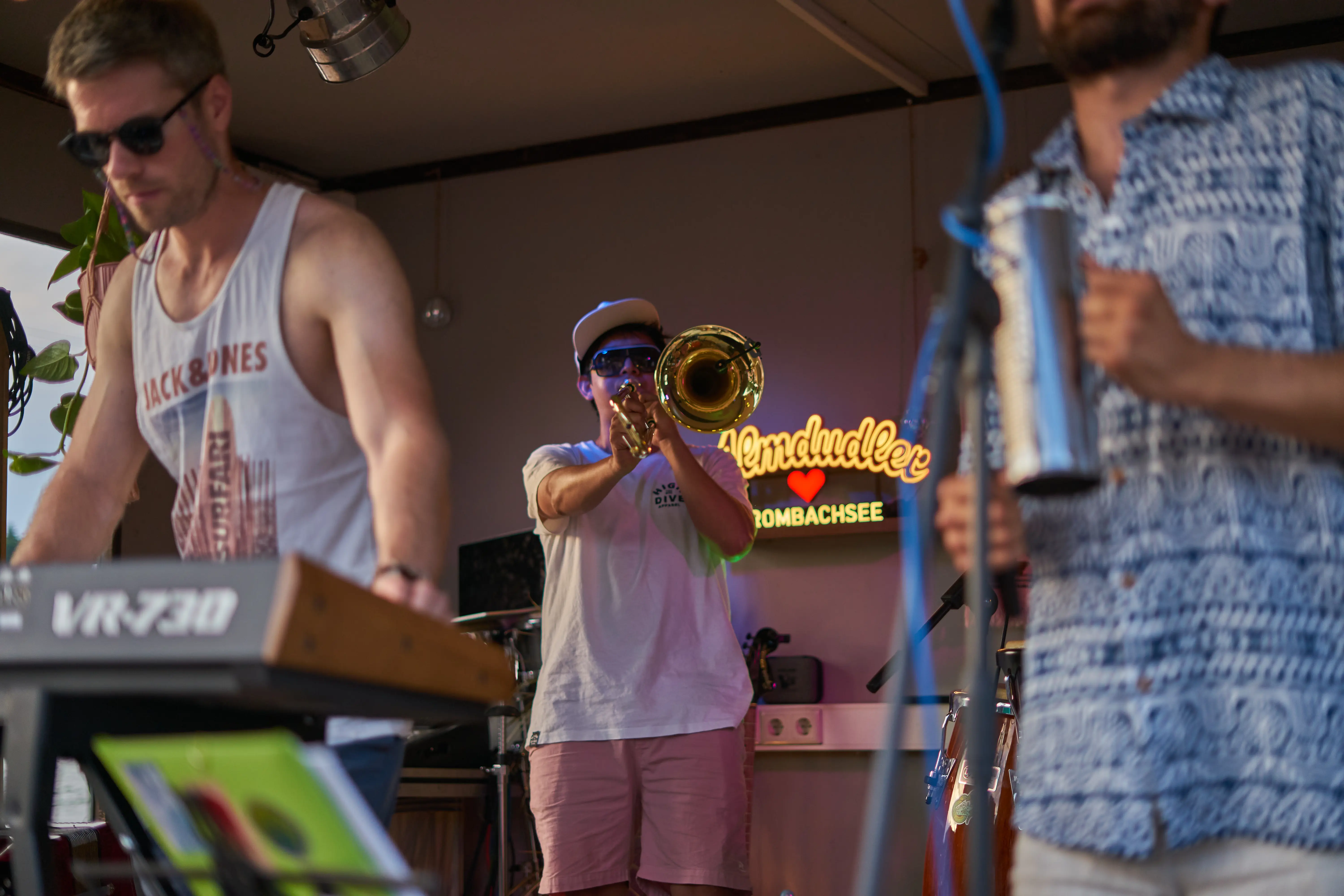Band playing on a stage, focus on the trombone player